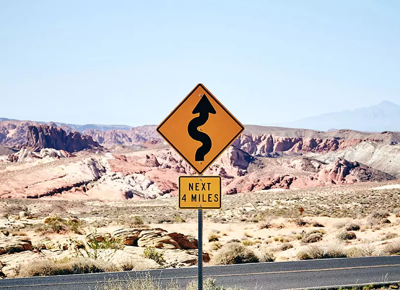 A roadsign with a wavy road