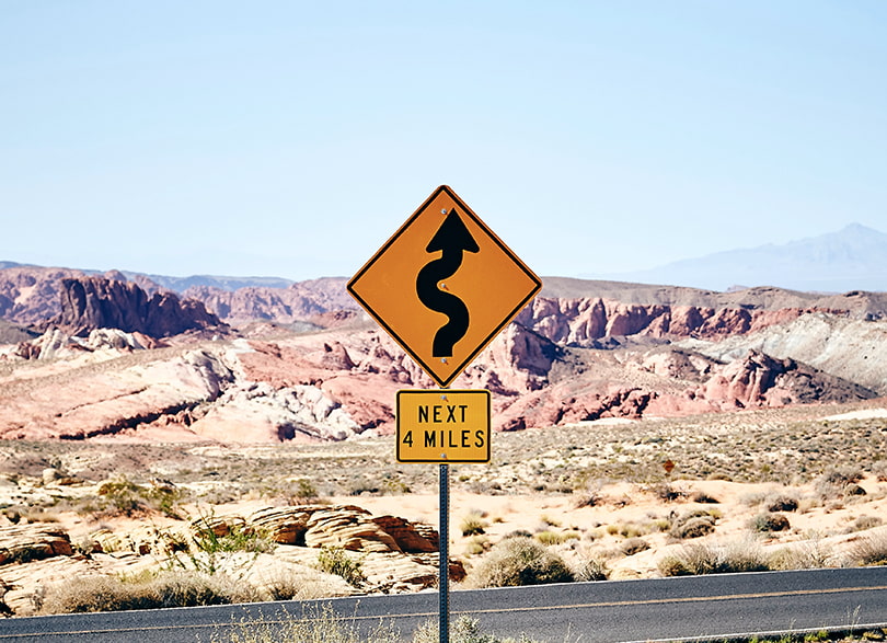 A roadsign with a wavy road