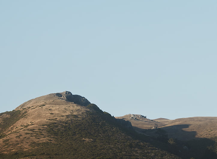 A large rolling hill under a blue sky