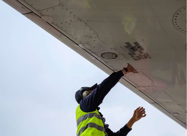 An aircraft worker prepping a craft