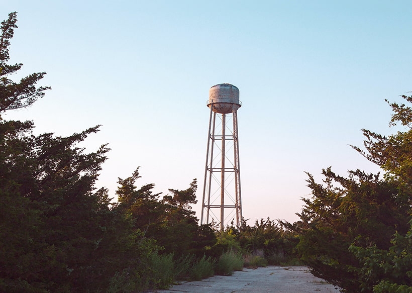 Water tower surrounded by trees